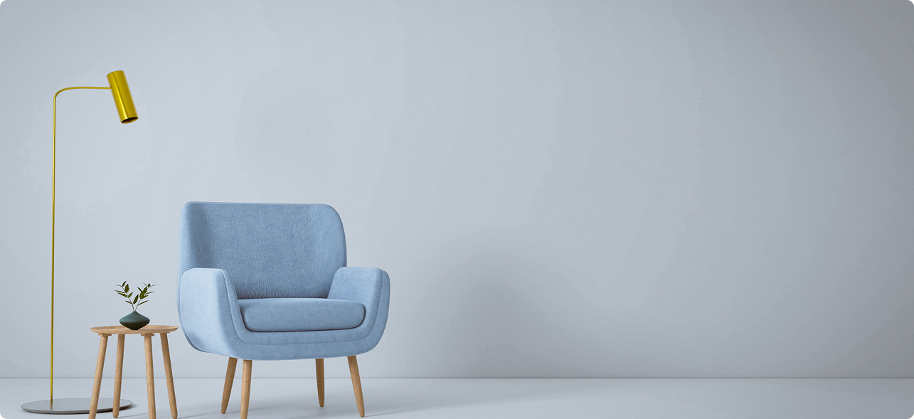 Stylish blue armchair with gold lamp and side table